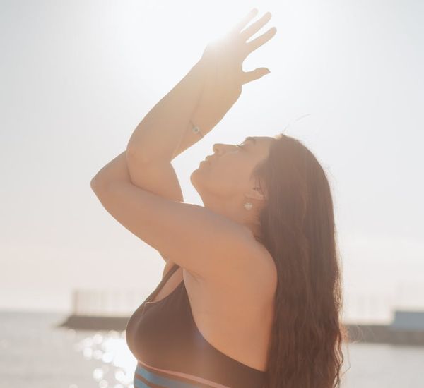 Silhouette of a person meditating at sunrise, symbolizing inner energy.